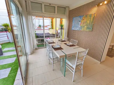 a dining room with a table and chairs at Penthouse with Private Rooftop & Seaview in Guia