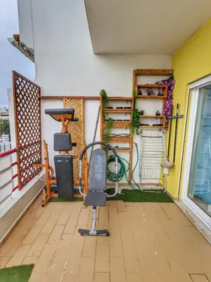 a balcony with a chair and a grill at Penthouse with Private Rooftop & Seaview in Guia