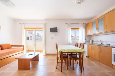 a kitchen and living room with a table and chairs at Recanto da Galé by Umbral in Albufeira