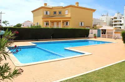 a villa with a swimming pool in front of a house at Recanto da Galé by Umbral in Albufeira