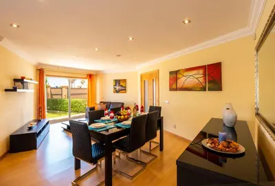 a living room with a dining room table and chairs at Villa Laguna by Algarve Vacation in Albufeira