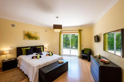 a bedroom with a large bed and a large window at Villa Laguna by Algarve Vacation in Albufeira