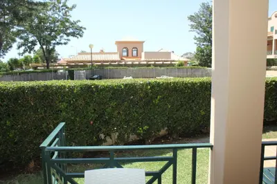 a view of a hedge with a building in the background at Villa V2 Z in Olhos de Água