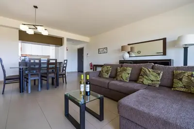 a living room with a couch and a table at BmyGuest - Cavalo Preto Beach Apartment in Loulé