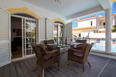 a patio with a table and chairs on a deck at Albuera Villa in Albufeira