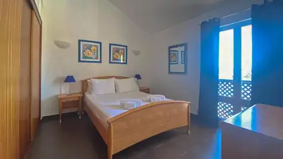 a bedroom with a bed and a blue and white room at Penthouse Duplex Marina Plaza T1 HsR Marina Vilamoura in Vilamoura