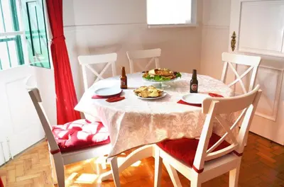 a table with a plate of food and two bottles of beer at Casa aOrta in Faro