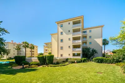 an apartment building with a lawn in front of it at WHome | Vilamoura Family Apartment in Quarteira