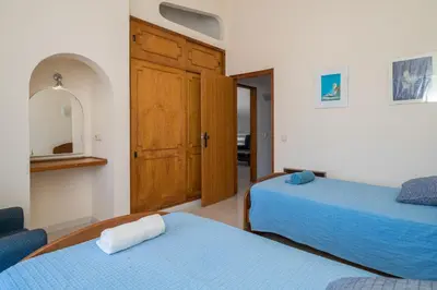 a bedroom with two beds and a mirror at Villa Lageado by IntiHolidays in Albufeira