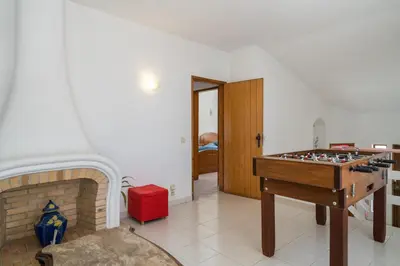 a living room with a chess table and a fireplace at Villa Lageado by IntiHolidays in Albufeira