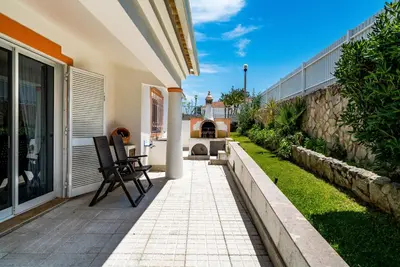 a patio with two chairs on a house at Villa Lageado by IntiHolidays in Albufeira