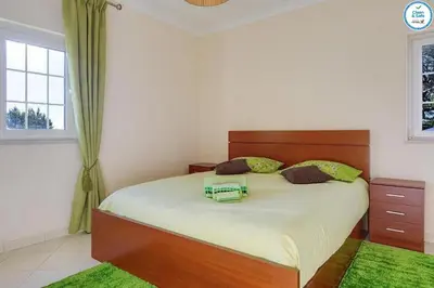 a bedroom with a large bed and a window at Villa Mikael - Free Wi-Fi - Aircon - Private Pool by bedzy in Albufeira