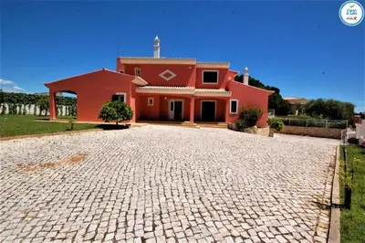 a red house with a brick driveway in front of it at Villa Mikael - Free Wi-Fi - Aircon - Private Pool by bedzy in Albufeira