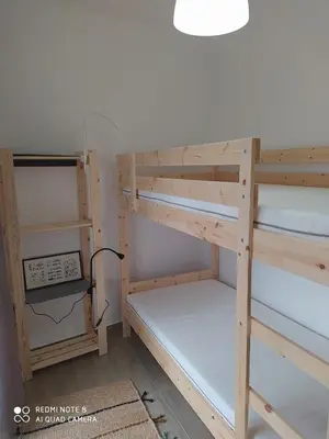 a couple of bunk beds in a room with a clock at Paradise in Olhos D'água Beach in Albufeira