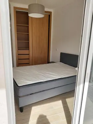 a small bedroom with a bed and a closet at Paradise in Olhos D'água Beach in Albufeira