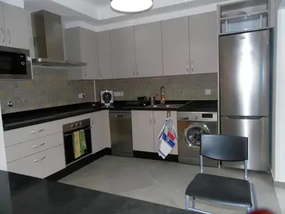 a kitchen with a stainless steel refrigerator and a dishwasher at Paradise in Olhos D'água Beach in Albufeira