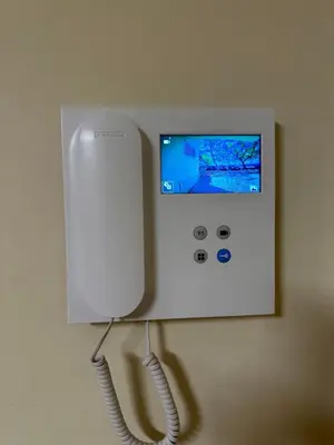 a white phone is on a wall in a room at Bellavista Modern Comfort, 3 Balcony, Family Apartment with Wi-Fi in Albufeira