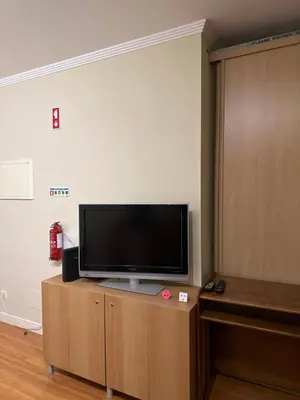 a flat screen tv sitting on top of a wooden cabinet at Bellavista Modern Comfort, 3 Balcony, Family Apartment with Wi-Fi in Albufeira