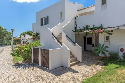 a white house with stairs in front of it at FLH Balaia Village Apartment with Pool I in Olhos de Água