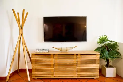 a living room with a tv on a wall at Albufeira Club 98 - O refúgio perfeito in Albufeira