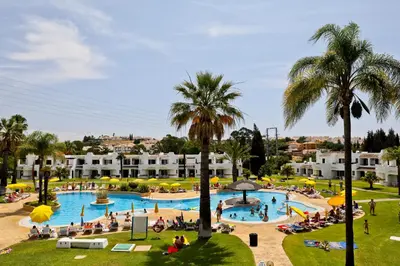 a large swimming pool with people in a resort at Albufeira Club 98 - O refúgio perfeito in Albufeira