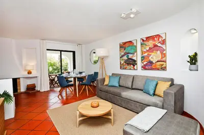 a living room with a couch and a table at Albufeira Club 98 - O refúgio perfeito in Albufeira
