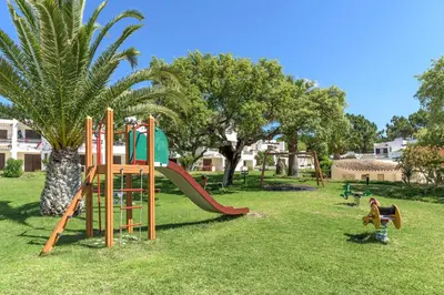 a playground with a slide in a park at FLH Balaia Village Apartment with Pool II in Olhos de Água