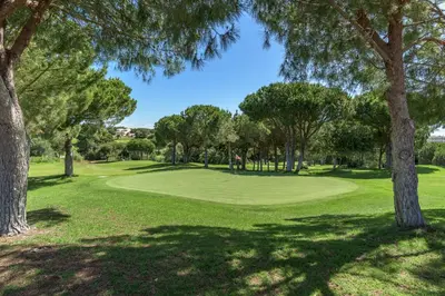 a view of a golf course with trees and a green at FLH Balaia Village Apartment with Pool II in Olhos de Água