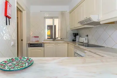 a kitchen with a plate on top of a counter at FLH Balaia Village Apartment with Pool II in Olhos de Água