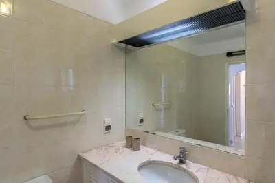 a bathroom with a sink and a large mirror at FLH Balaia Village Apartment with Pool II in Olhos de Água