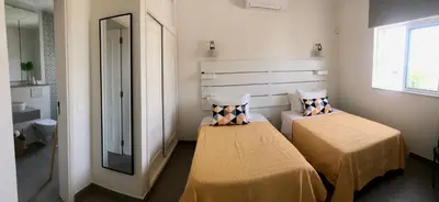 a small room with two beds and a mirror at Casa Netos in Galé