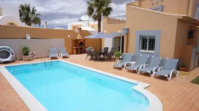 a swimming pool in front of a house at Casa Netos in Galé