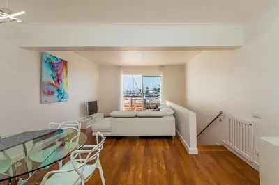 a living room with a couch and a glass table at Onde a Marina é Casa T2 HsR Vilamarina in Vilamoura