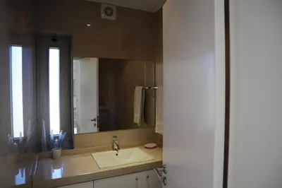 a bathroom with a sink and a large mirror at Villa dos Salgados - Beachfront, 6 Golf Courses, 6BDR in Guia