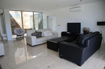 a living room with a couch and a tv at Villa dos Salgados - Beachfront, 6 Golf Courses, 6BDR in Guia