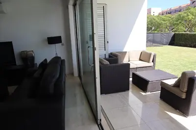 a living room with chairs and a sliding glass door at Villa dos Salgados - Beachfront, 6 Golf Courses, 6BDR in Guia