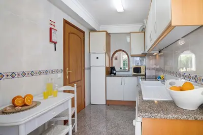 a living room with a couch and a table at Villa Paradise in Olhos de Água
