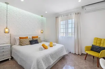 a kitchen with a table with a bowl of fruit on it at Villa Paradise in Olhos de Água