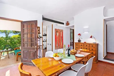 a villa with a swimming pool and chairs and a house at Villa Simão in Quinta da Balaia in Albufeira