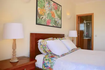 a bedroom with a bed and a picture on the wall at VILA CRISTINA MAR (8 guests and oceanview) in Albufeira