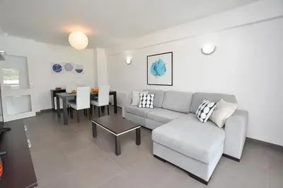 a living room with a couch and a table at Tenis Golf Mar by OCvillas in Quarteira