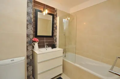 a bathroom with a sink and a tub and a mirror at Tenis Golf Mar by OCvillas in Quarteira