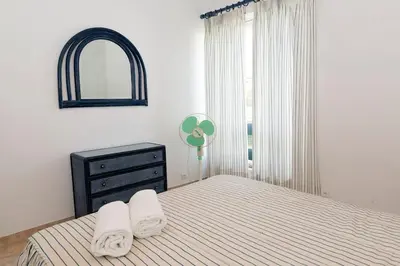 a bedroom with a bed and a dresser and a window at TAC - Vilamoura Center in Vilamoura