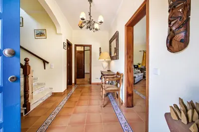a hallway with a table and chair in a house at Villa Hideaway by Algarve Villa Holidays in Galé