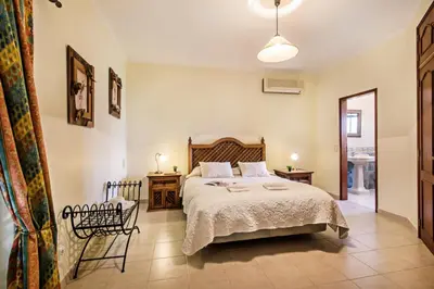 a bedroom with a bed and a table and chairs at Villa Hideaway by Algarve Villa Holidays in Galé