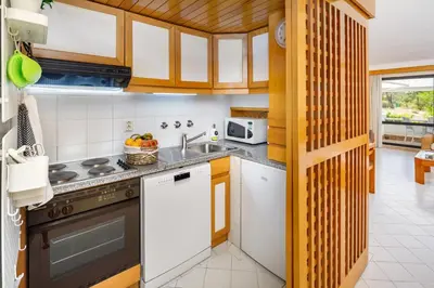 a kitchen with a sink and a stove at Victory Village T1 & Rooftop terrace in Quinta do Lago