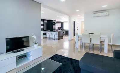 a living room with a couch and a tv and a kitchen at Villa Cantinho by Intiholidays in Albufeira