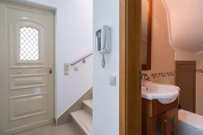 a bathroom with a sink and a door at Villa Cantinho by Intiholidays in Albufeira