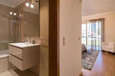 a bathroom with a sink and a toilet and a tub at Villa Cantinho by Intiholidays in Albufeira