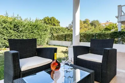 two chairs and a table on a patio at Villa Cantinho by Intiholidays in Albufeira